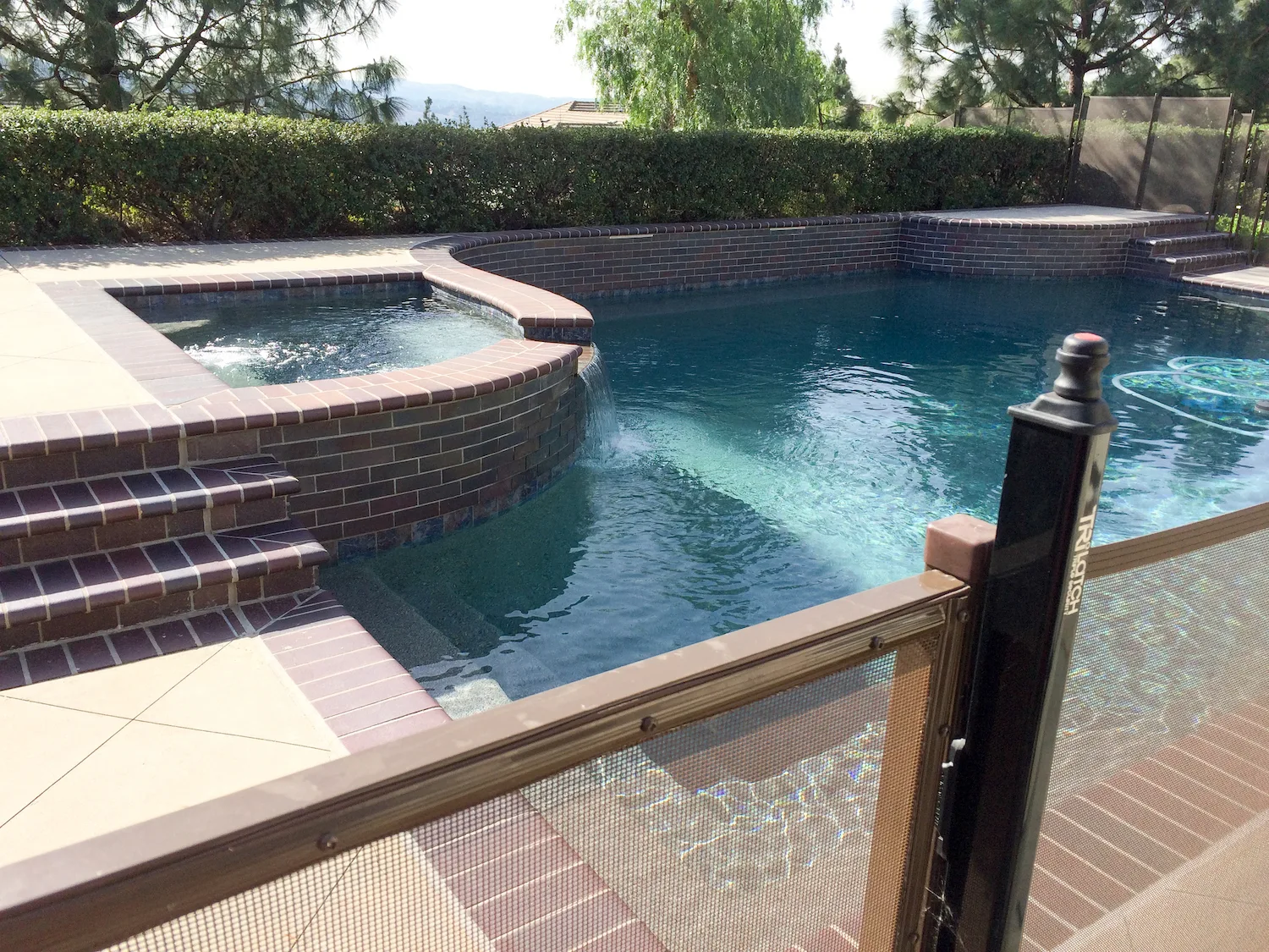 A self-closing pool safety gate set into a fence line