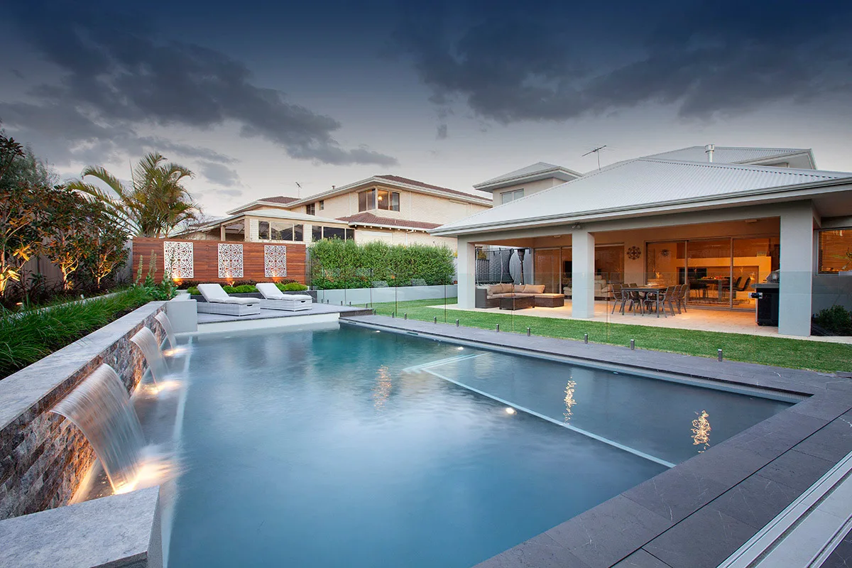 A modern Brisbane home with a pool at dusk